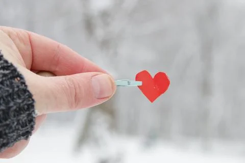 Creative winter background with blue paper heart. Stock Photos