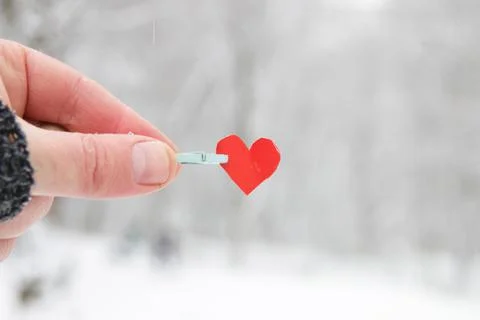 Creative winter background with blue paper heart. Stock Photos