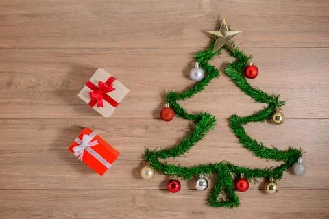 Creative winter layout made with evergreen tree branches and ornament, gift b Stock Photos