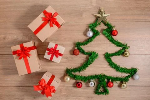 Creative winter layout made with evergreen tree branches and ornament, gift b Stock Photos