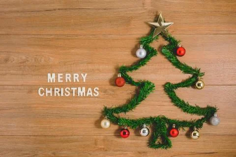 Creative winter layout made with evergreen tree branches and ornament on wood Stock Photos