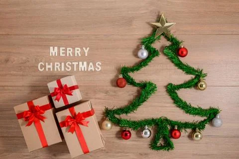 Creative winter layout made with evergreen tree branches and ornament, gift b Stock Photos