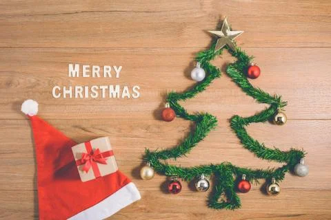 Creative winter layout made with evergreen tree branches and ornament, gift b Stock Photos