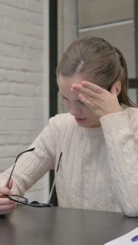 Creative Woman having Headache while Sitting at Work, vertical video Stock Footage 325832420