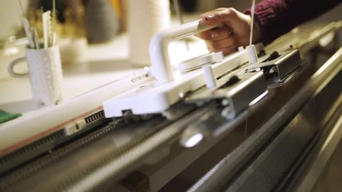 Creative woman making knitted texture on weaving machine in workshop Stock Footage 87377850