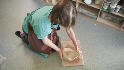 Creative woman methodically molding and shaping clay in studio. Dedicated Stock Footage 342282056