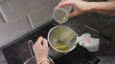 Creative Woman Pours Melted Sugar Into Bowl While Preparing Mixture in Kitchen Stock Footage 307990669