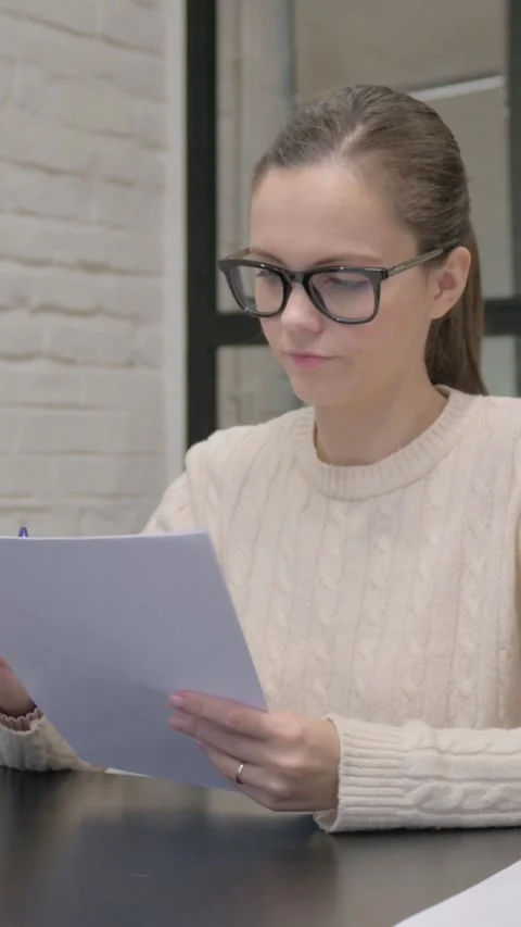 Creative Woman Reading Documents at Work, vertical video Video stock 325832212