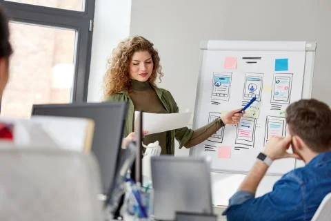 Creative woman showing user interface at office 스톡 사진