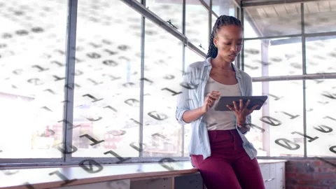 Creative woman tapping tablet and causing animated binary overlay while Stock Footage 333526411