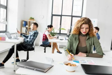 Creative woman working on user interface at office Stock Photos