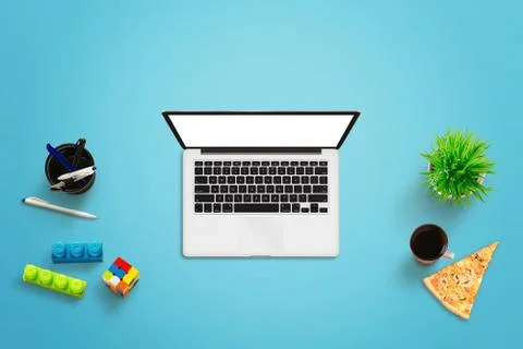 Creative work place. Top view of blue desk with laptop computer, green plant, Stock Photos