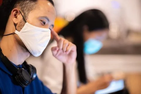 Creative worker team wearing face mask, working at business co-working space Stock Photos