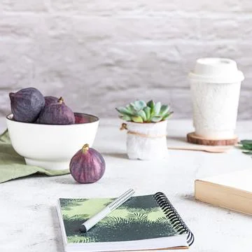 Creative workplace with a bowl of figs, side view. Stock-Fotos