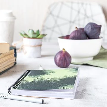 Creative workplace with a bowl of figs, side view. Stock-Fotos