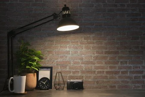 Creative workplace with camera, picture frame, alarm clock and potted plant o Stock Photos