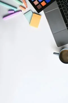 Creative workplace with laptop computer, sticky notes, coffee cup and color Stock Photos