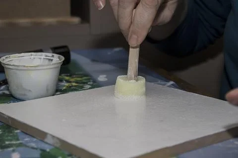 Creative workshop activity featuring hands crafting with paint on a canvas .. Foto stock