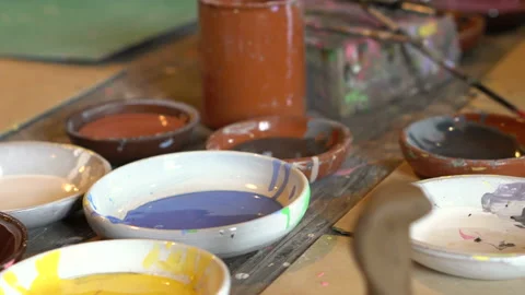 Creative workshop. Masters paint toys. Brushes and paints on the table. Stock Footage 107487457