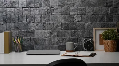 Creative workspace with books, alarm clock, coffee cup and picture frame on Foto stock