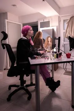 Creative workspace with individuals collaborating and using a computer Stock Photos