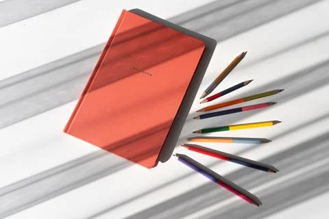 Creative Workspace with Notebook and Colorful Pencils in Natural Light Stock Photos