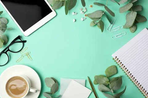Creative workspace with tablet, glasses, notebook, and plants Stock Photos