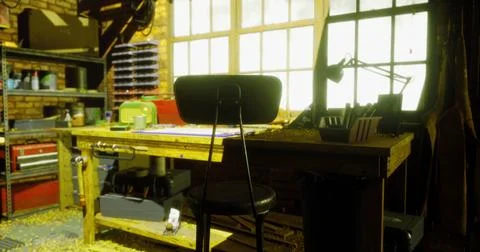 Creative workspace in a warm, rustic studio filled with natural light Stock Illustration