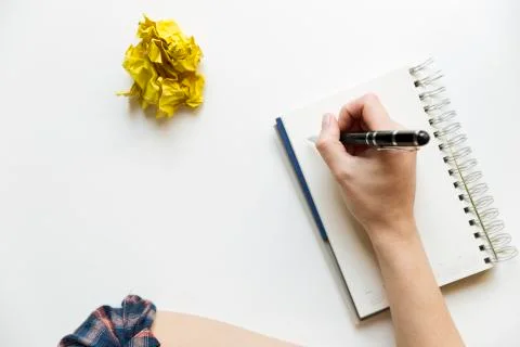 Creative writing concept with notebook and crumpled paper balls. Editing and Stock Photos