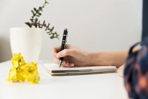 Creative writing concept with notebook and crumpled paper balls. Editing and Stock Photos