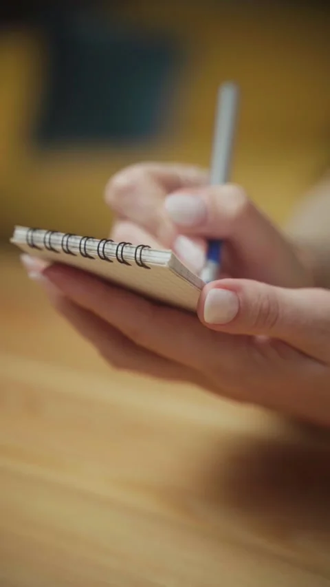 Creative writing practice in a cozy environment with a notebook and pen Stock Footage 303768237