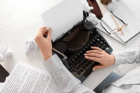 Creative writing process with vintage typewriter, blank paper, and crumpled d Stock Photos