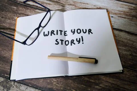 Creative writing prompt on an open notebook with glasses Stock Photos
