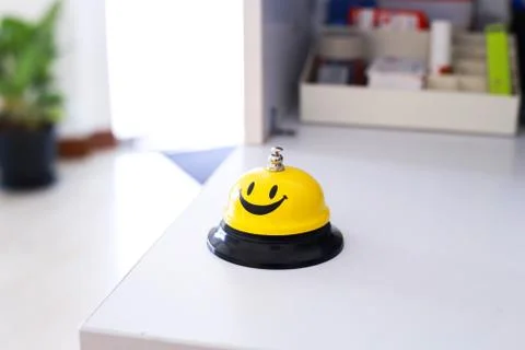 Creative yellow smiling table bell in multiple angle Stock Photos
