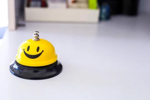 Creative yellow smiling table bell in multiple angle Stock Photos