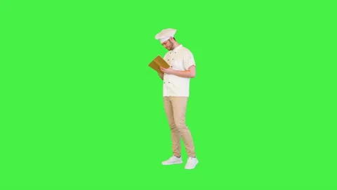 Creative young chef planning list of ingredients and menu for festive dinner in Stock Footage 157328481