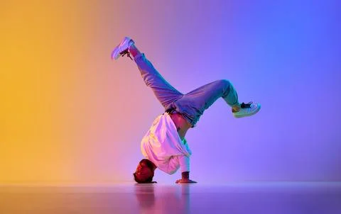 Creative young guy in casual clothes dancing hip-hop contemporary, breakdance Foto stock