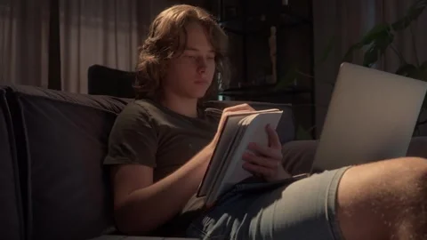 Creative young man journaling or sketching in a notebook late at night Stock Footage 310739277