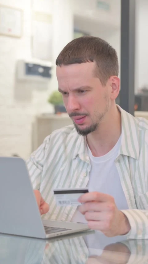 Creative Young Man Upset with Online Banking Failure on Laptop, vertical video Vidéo 325563905