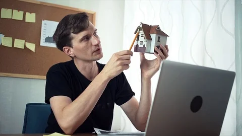 Creative young man using laptop computer in the home office Stock-Footage 79897742