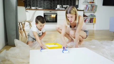 Creative young mother with son draws on canvas Stock Footage 164041129