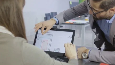 Creative young professionals discussing the product design using a touchscreen Stock Footage 73993909