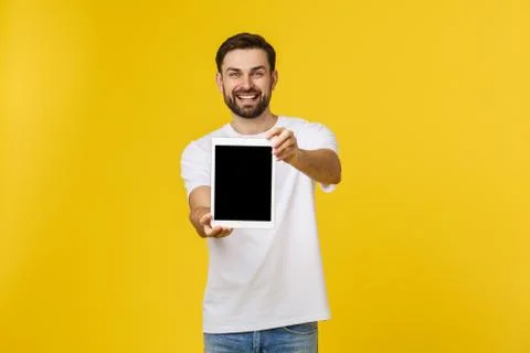 Creative young programmer presents with a smile on his face display a tablet. Foto stock