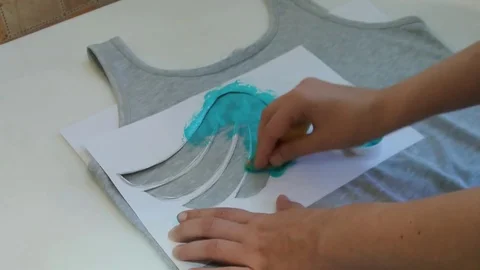 Creative young woman prints pattern on the shirt. Stock Footage 82782948