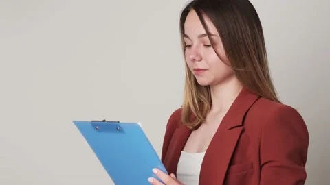 Creative young woman taking notes in paper notebook Stock Footage 163314738