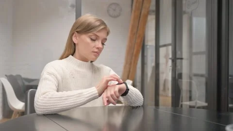 Creative Young Woman Using Smart Watch at Workplace Stock Footage 303880857