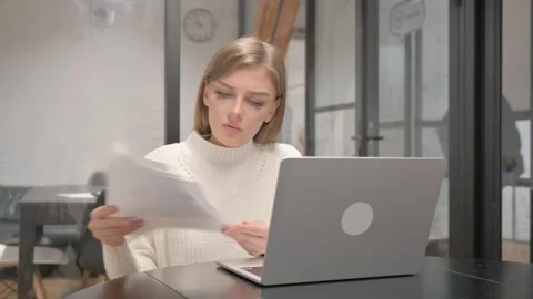 Creative Young Woman Working on Documents and Laptop Stock Footage 303880650