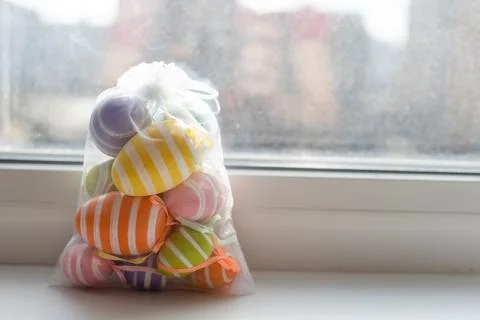 Creatively Easter painted eggs in a bag on a white background. Flat lay, copy Stock Photos