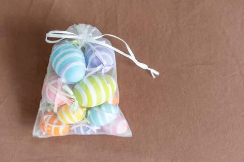 Creatively Easter painted eggs in a bag on a gray background. Flat lay, copy 스톡 사진