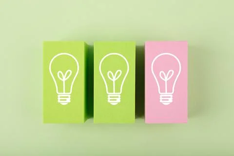 Creativity and fresh idea concept. Light bulbs on green and pink toy blocks Stock Photos